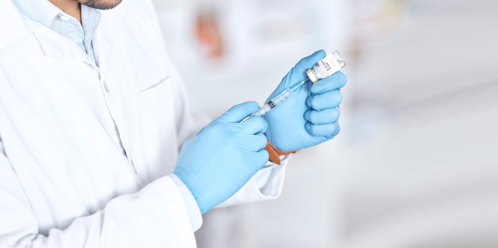 Healthcare professional holding a peptide vial and syringe for the Retatrutide Canada guide
